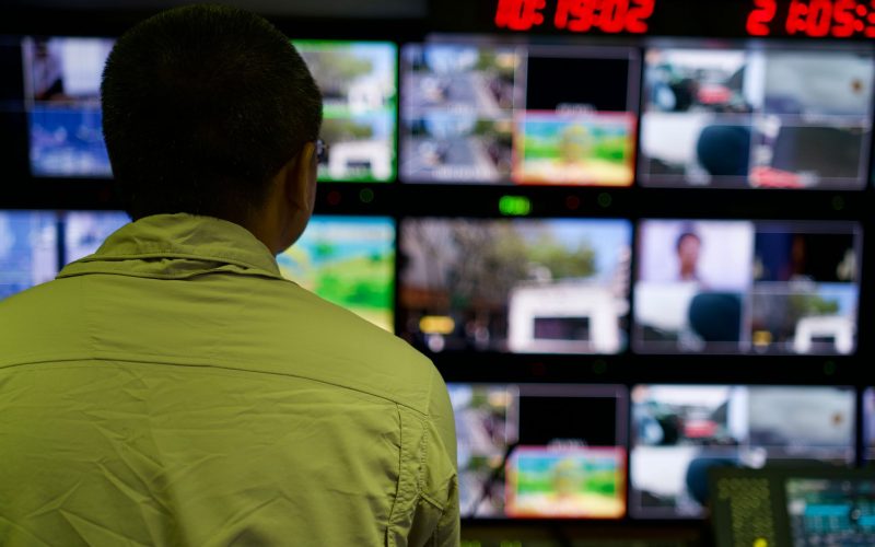 Man monitoring security cameras